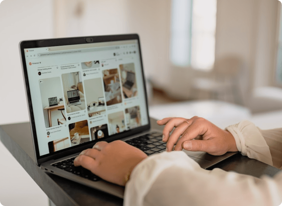 Person tracking Pinterest analytics on a laptop