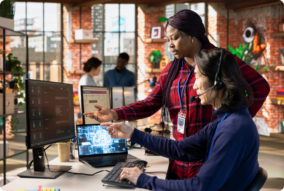 Two professionals discussing e-commerce strategy in front of a computer monitor